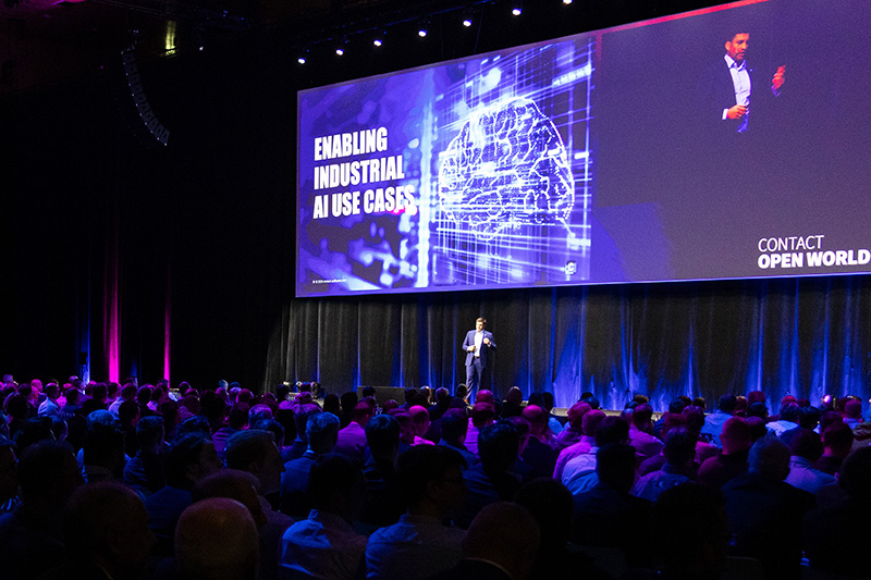 CONTACT’s Managing Director Max Zachries on a conference stage in front of a presentation titled “Enabling Industrial AI Use Cases.”